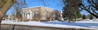 View of the front of the library building in winter against a blue sky